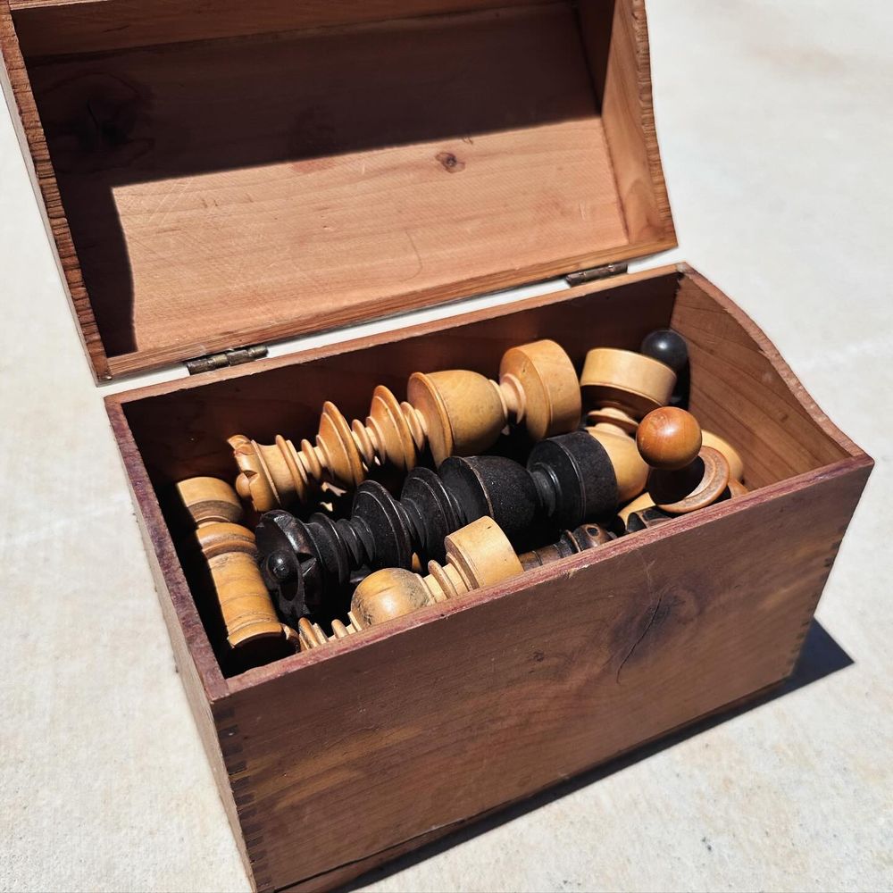 hand-carved wooden chess set in a handmade wooden box.