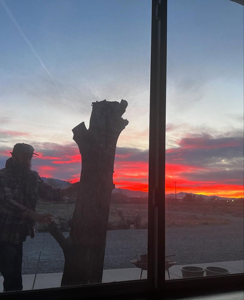 View of a beautiful sunrise (and Ken) un-obscured by a solar screen window cover.