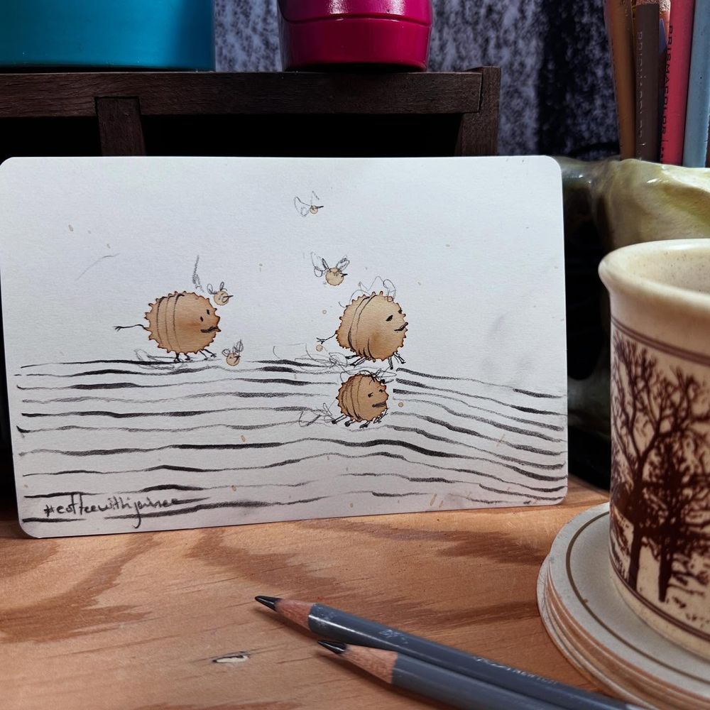 Doodles over dried coffee spills. Looks like three strange land-roving creatures out for a walk.