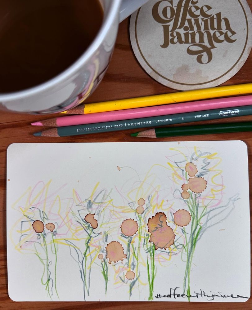 Doodles over dried coffee spills that look like a small cluster of lovely flowers.