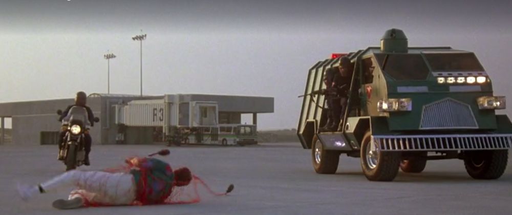 Running Man. Arnie's character is chased by government agents in an armored truck and on a motorcycle. One agent stops Arnie by shooting a net at him.