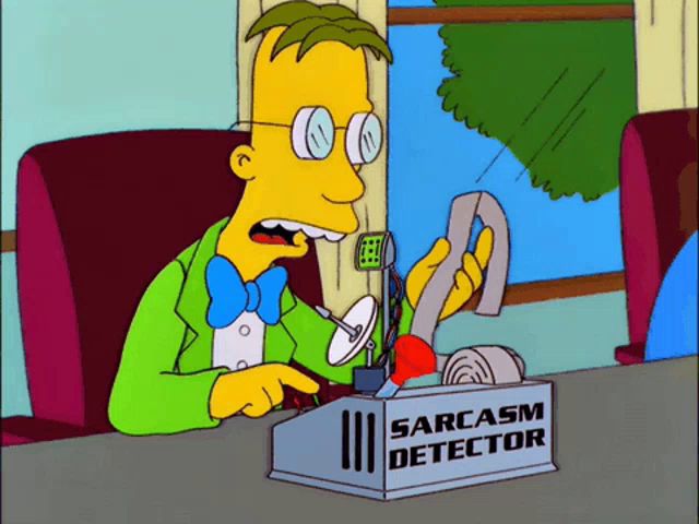 a cartoon character is sitting at a desk with a sarcasm detector in front of him