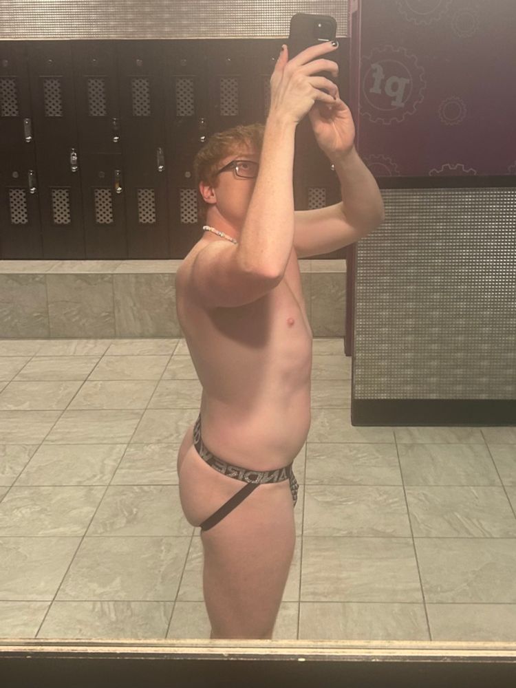 I’m standing at the mirror in the Planet Fitness locker room. Holding my phone up for a selfie. Wearing a black Andrew Christian jockstrap. 