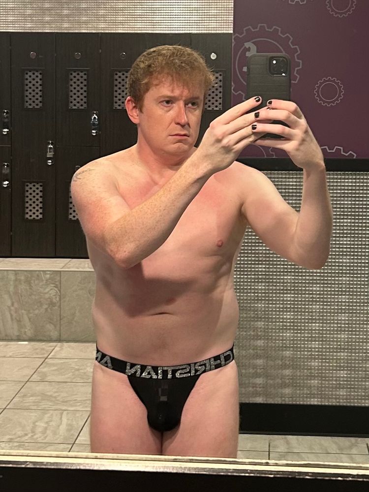Locker room selfie in a black Andrew Christian jock. Front view with cage outline. 