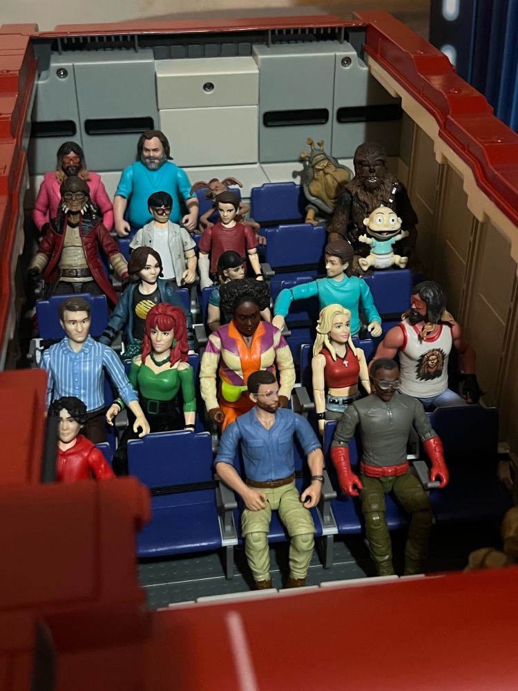 Tourists listen to the flight agenda before take-off. This is an assortment of normal looking characters that could pass for tourists. I realized too late that they don’t have 3D glasses and I shall not be making any. They are on the 2D version of the ride that exists because I say so.