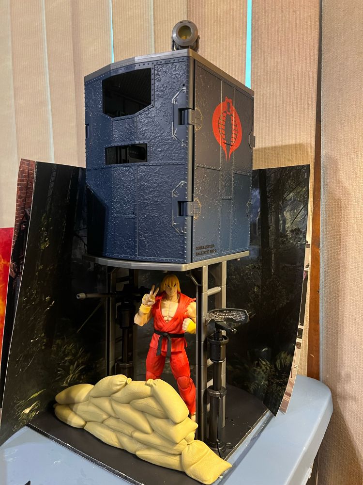 Cobra Beach Bungalo. The small bunker is elevated by ladders and sandbags are an additional measure against high tide, with Ken Masters prepared to Dragon Punch the living shit out of any moisture that dares trespass further. He’s a G.I.Joe! Mattel didn’t like that! Remember!!!!???? (I tell this to everyone, including your family)