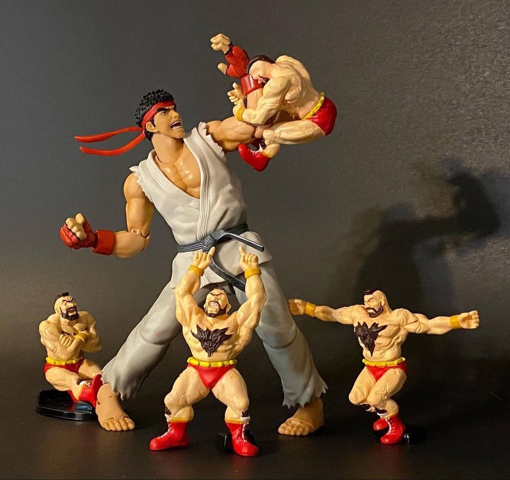 Ryu fends off tiny Zangiefs giving him some Zangrief!
I used to pronounce it zan-GEEF, but when reading it in a comical Russian accent, it’s more of a ZON-gyef. I won’t be looking it up, I just figured I’d waste your time.

How about that thick chest hair and the way he has straight up SHIN FUR tucked into his boots. Shin Fur sounds like a Street Fighter character. Alright, punching out.