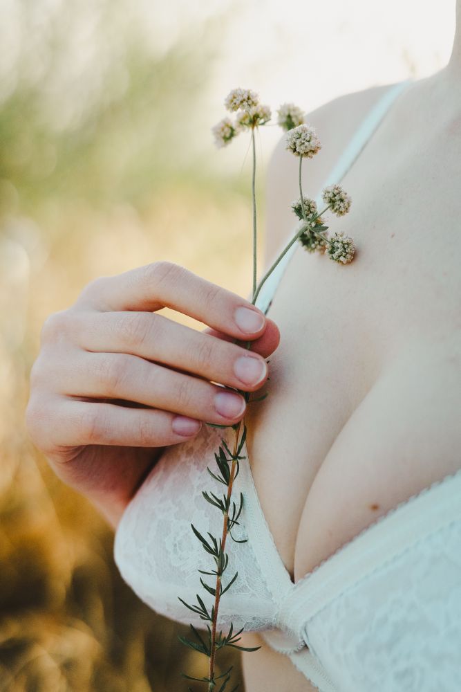 Ayala holds a collection of flowers close to their breast