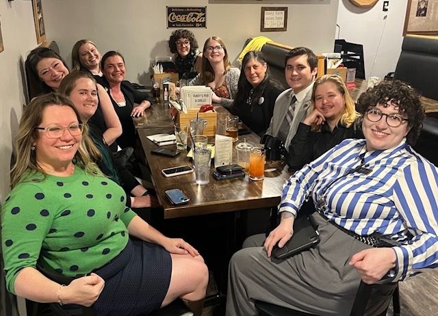 Photo of NH State Reps and Executive Council having lunch at a restaurant. All are smiling.