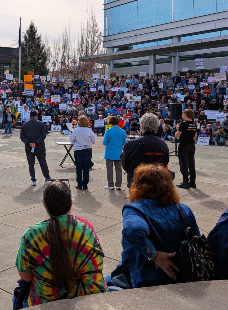 Local and national elected officials stand before a crowd in Washington Country to support a government powered by people.