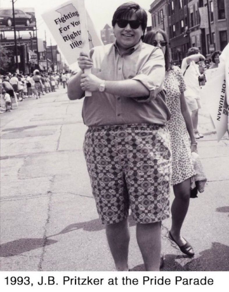 A black and white picture of a young JB Pritzker standing for queer rights in 1993 with sunglasses with the fanciest shorts you’ve ever laid your eyes on. It’s like some sort of trippy tie dye thing or one of those books where you can see hidden images in a pattern. But that hidden image spells out, “JB Pritzker will run for President in 2028”