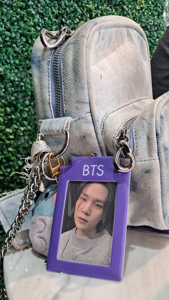 hobi denim purse with mang plushie keychain and purple photocard holder with an Agust D photocard