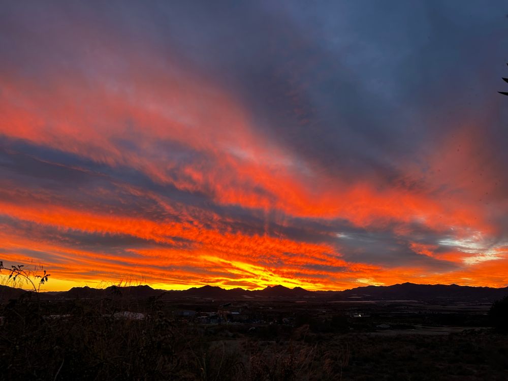 Orange, yellow and deep blue hues dominate the sky and sundown