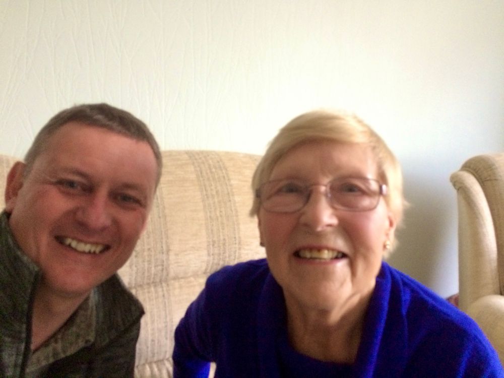 Picture of Simon and Valerie who is wearing a royal blue cardigan 