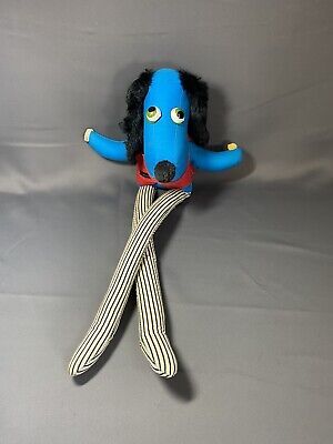 stylish blue dog with red jacket and long striped legs