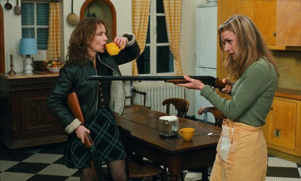 La Cérémonie (1995)
dir: Claude Chabrol

Isabelle Huppert drinking coffee while Sandrine Bonnaire points a shotgun off screen 