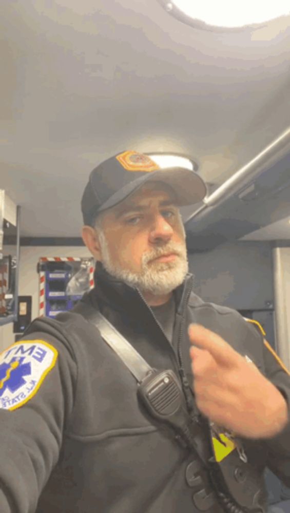 a man wearing a black jacket with a patch that says ems