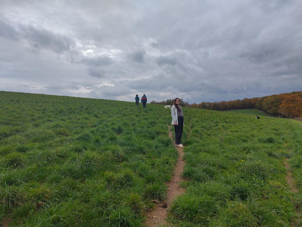 Me, in the middle of a green grassy open field against a cloudy sky