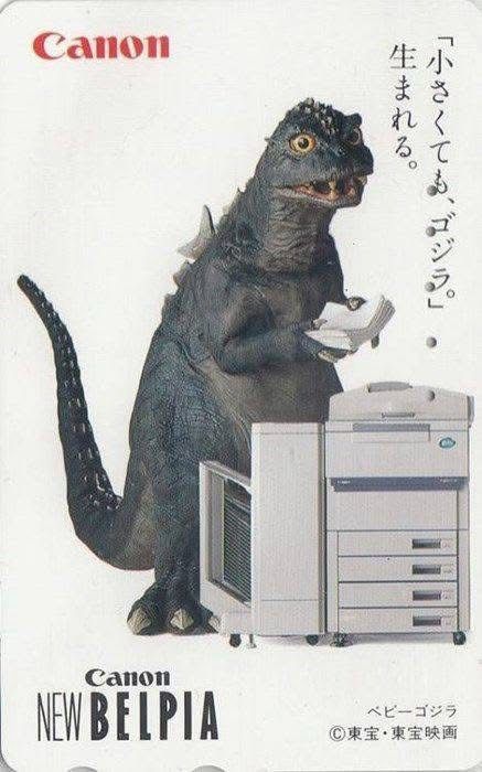 Advertisement for Canon. Godzilla stands next to a copy machine with paper in his hands.