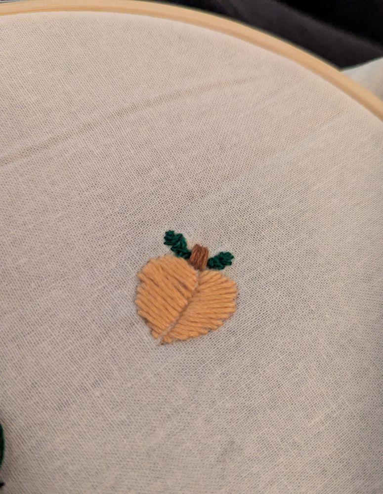 An embroidered peach