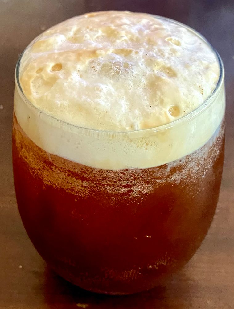 An iced americano made with cherry blossom flavored carbonated water.