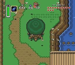 A screenshot of Link to the Past, showing the tree sprite in question front and center. The tree trunk has three symmetrical roots at the base that my brain interpreted as toes, especially with how they are segmented. Its worth mentioning that I only saw the bottom half because of how screen transitions worked, and I encountered this sprite during the rainy part of the game at the very start, which certainly didn’t help the matter. 