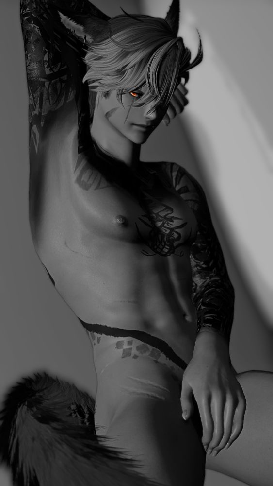 Picture of a cat boy in black and white, naked with his left hand covering his crotch; the cat boy has numerous geometrical looking tattoos littered across his body,. His right arm is raised behind his head while his bright sunset eyes look at the camera.
