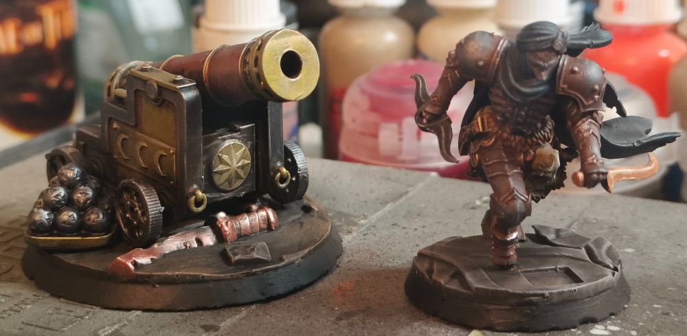 Painted miniatures from the game Trench Crusade. A third party Sultanate grand cannon and an official assassin sculpt