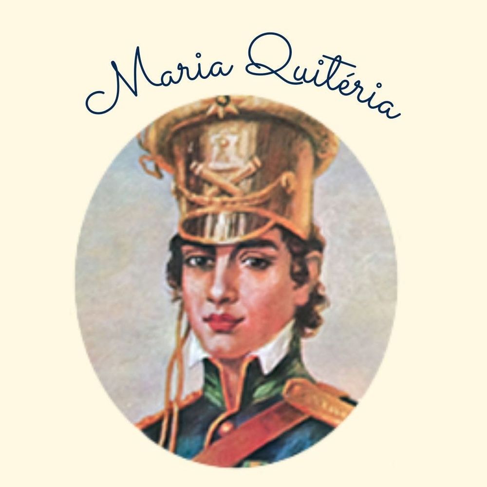 Mesma imagem de Maria Quitéria do post anterior, vestindo farda azul, com detalhes dourados, verdes e vermelhos, e olhando séria para a câmera, em uma moldura oval. Em cima, o nome dela escrito com letra cursiva.