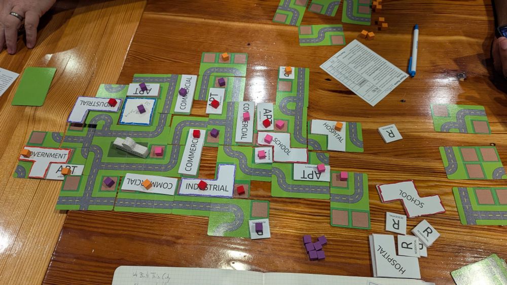 We Built This City shown in a table. Final layout and scoring in a 4 player game.