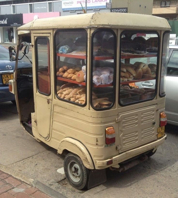 What I would describe as like, a bread tuk-tuk. Three wheel metal car with shelves of baked goods in the back
