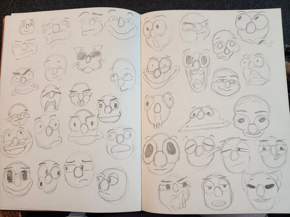 A large array of cartoonish expressions drawn onto paper using grey lead. Most faces are stretched in various ways to exaggerate the different expressions. There are thirty-nine total faces.