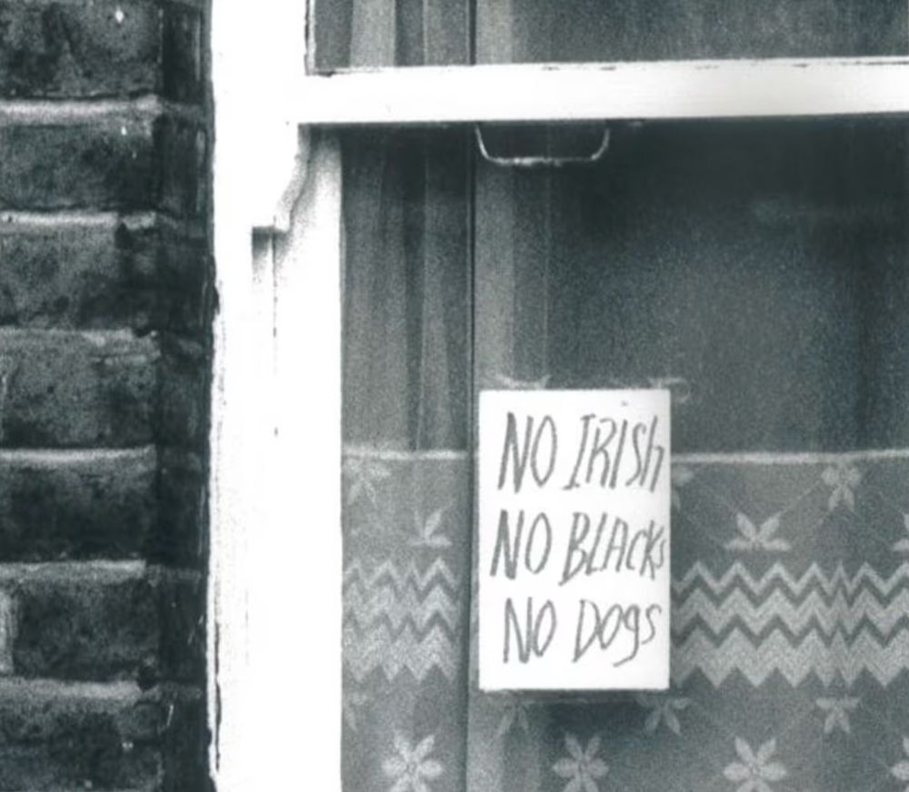 A sign in a window that reads:
No Irish
No Blacks
No Dogs