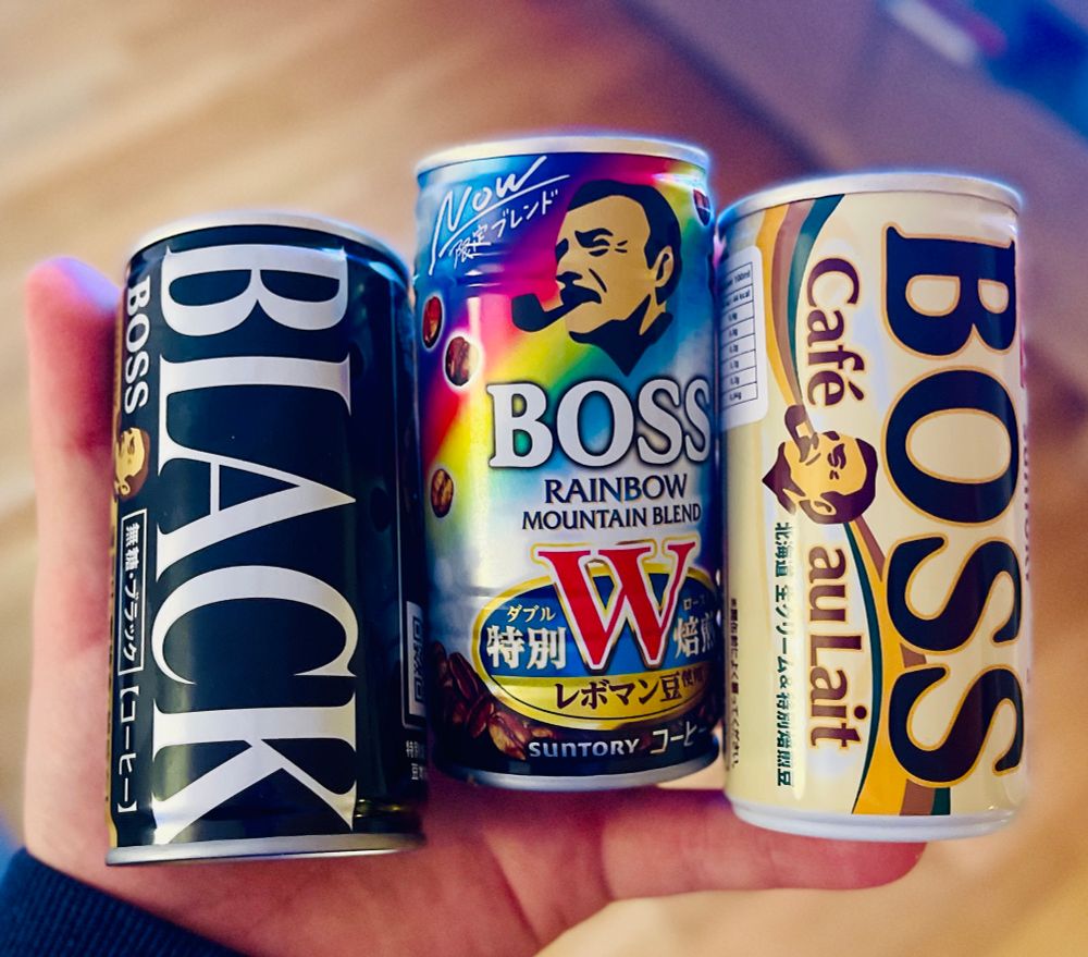 Im holding 3 cans of different Japanese coffee.