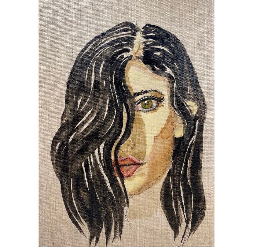 Iranian woman wearing her long, black hair open. Half of her face is hidden behind the hair.