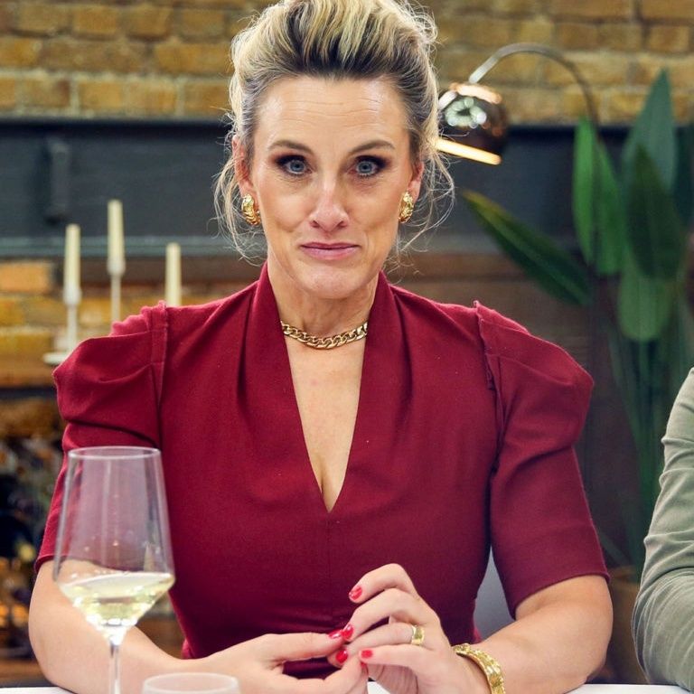 A picture of Masterchef judge Grace Dent looking directly to camera in a red dress.