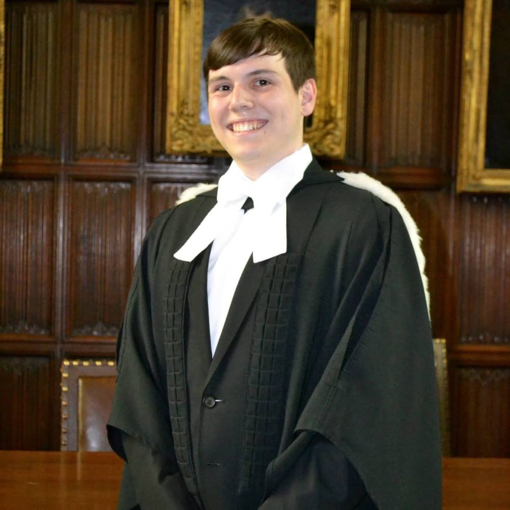 Richard Kish in graduation gown and hood in the formal hall of Christ's College, Cambridge