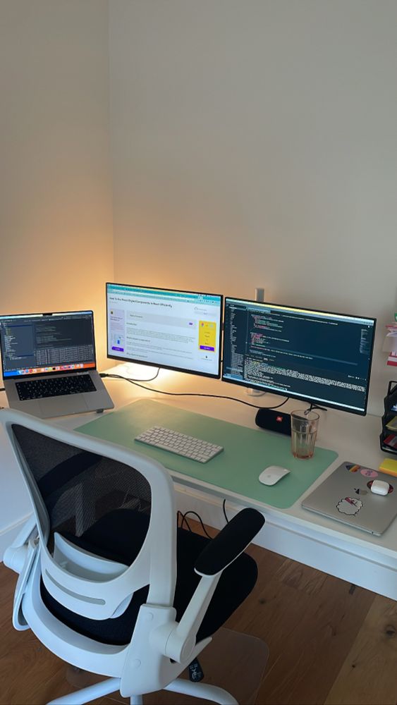 Desk setup with a laptop and two monitors