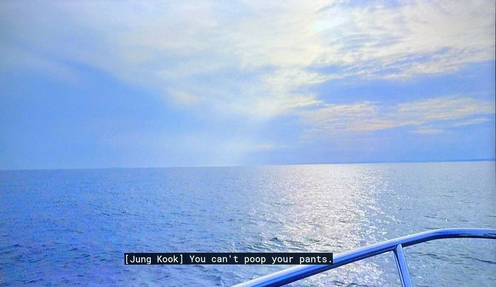 AYS show scenic shot of the blue ocean afternoon with sky off the bow of the ship but the caption is: [Jung Kook] You can't poop your pants.