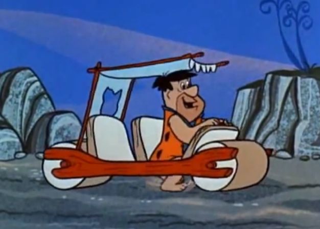 Fred Flintstone in his car.