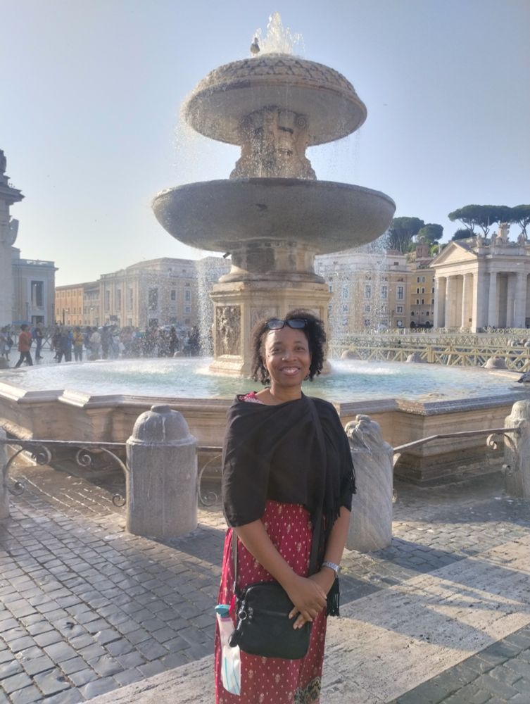 Standing in front of a fountain in St. Peter's Square, Rome, Italy