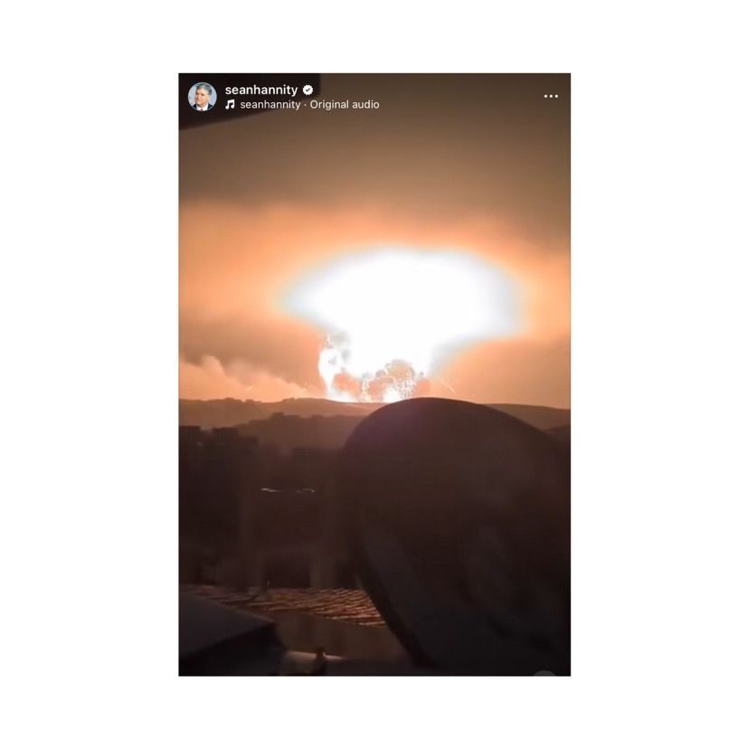 Alt text: A screenshot from Sean Hannity’s Instagram story shows a massive fiery explosion lighting up the night sky over a distant landscape, with a large white flash and rising smoke resembling a blast cloud. A dark silhouette of a rooftop and satellite dish is visible in the foreground.