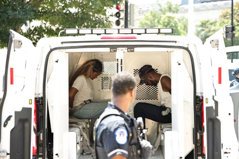 Raquel Willis of GLM and another protestor in police van arrested
