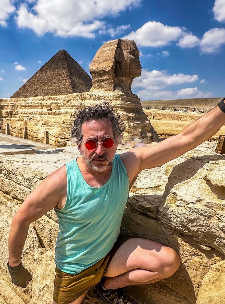 Me dressed as Larry Croft, Tomb Raider, in front of the Sphinx and Great Pyramid in Egypt