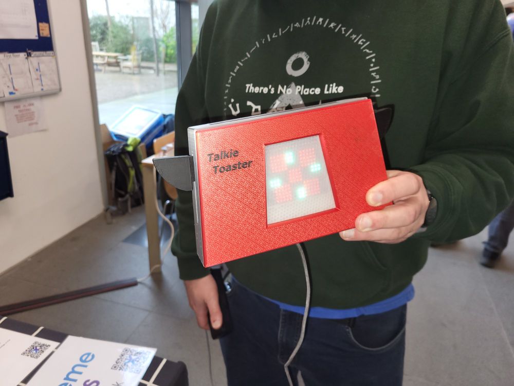 Red 3d printed box with lights of the front  labelled talkie toaster
