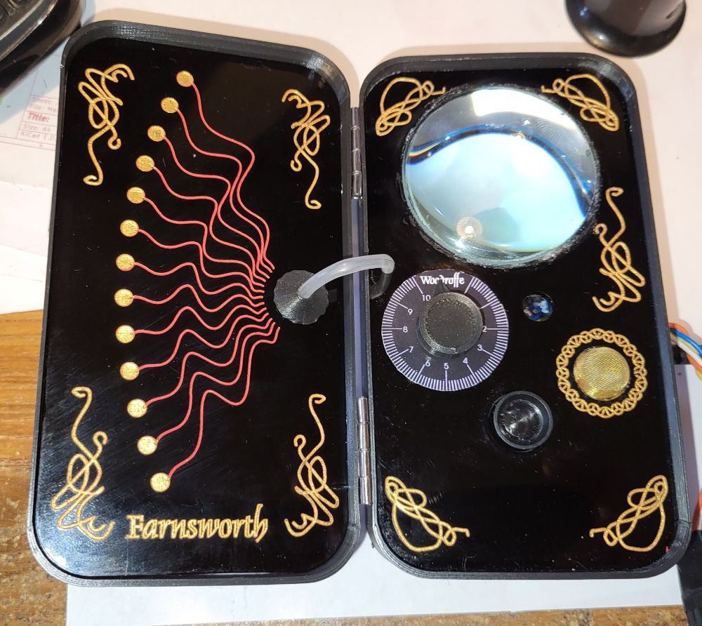 Philo Farnsworth's communicator from Warehouse 13 Black case. with engraved patterns Large lens and a couple of knobs. Gold gause microphone cover. 