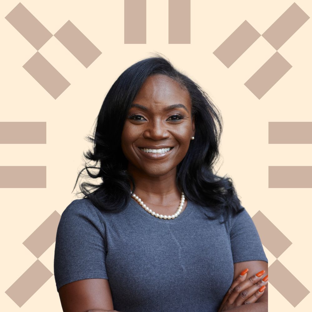 Dr. Kizzmekia Corbett-Helaire wearing a gray shirt and a pearl necklace. 
