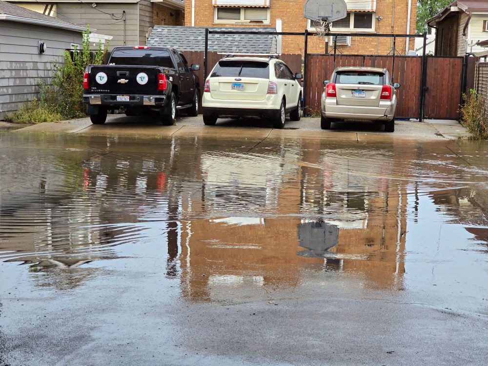 An alley completely covered in a few inches of standing water.