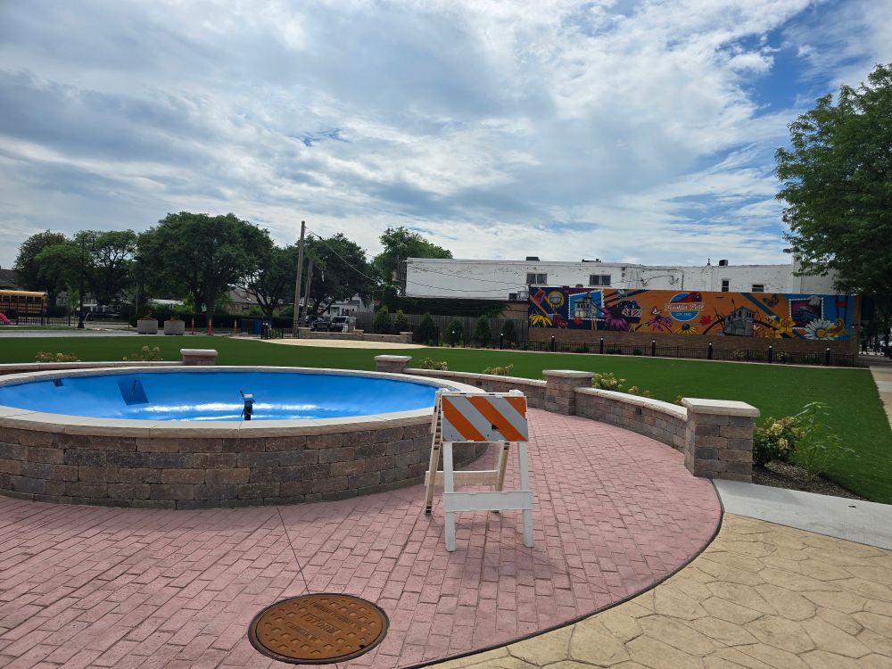 A new plaza in Franklin Park onnthe corner of Franklin & 25th, featuring a not yet in-service fountain and a mural heavily featuring railroads.