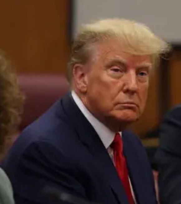 Picture of Donald Trump dead-eye stare while sitting in court. 